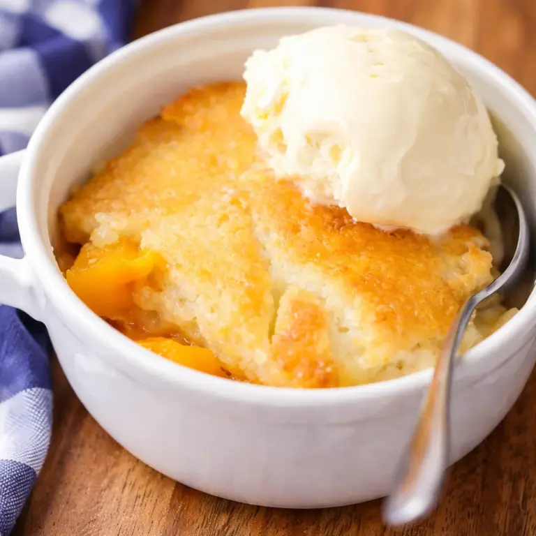 Delicious peach cobbler with canned peaches topped with buttery crust.