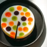 Colorful Yogurt Rainbow Polka Dot Jello dessert served in a glass dish.