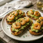 Garlic Shrimp Crostini with diced avocado on toasted bread